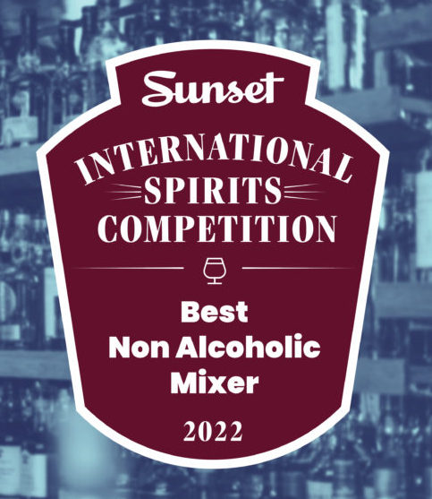 Caged Heat cocktail syrup featuring tamarind, cardamom, and ghost pepper in elegant glass bottles.