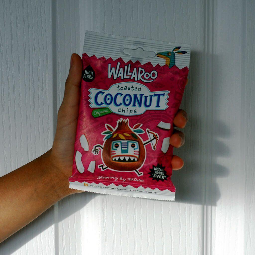 A box of Organic Toasted Coconut Chips with individual 30g bags, showcasing thick cut, crunchy coconut chips.