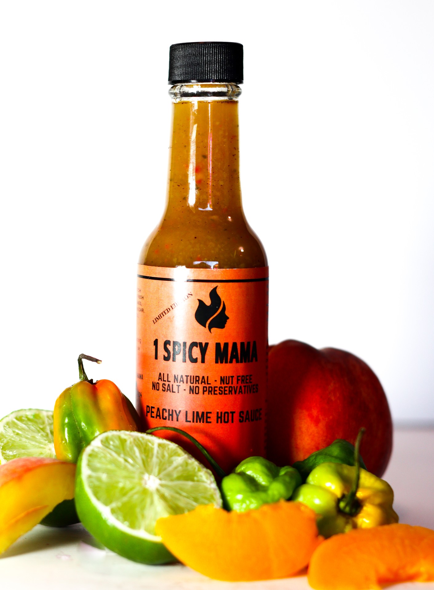 A bottle of Peachy Lime Hot Sauce with vibrant colors, showcasing the blend of peaches and scotch bonnet peppers.