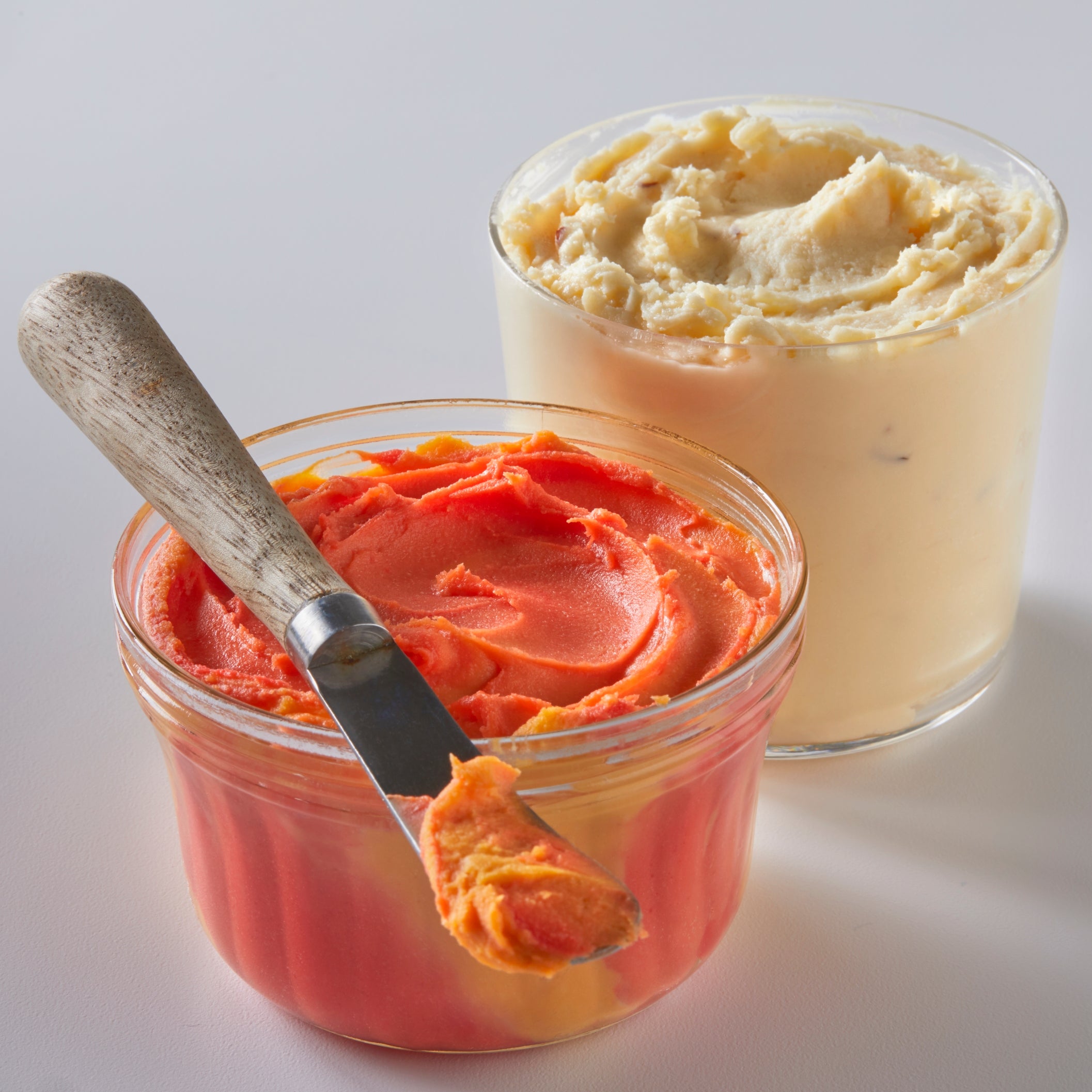 A creamy Port Wine Cheese Spread in a 9 oz container, showcasing its rich texture and inviting color, perfect for spreading on crackers.