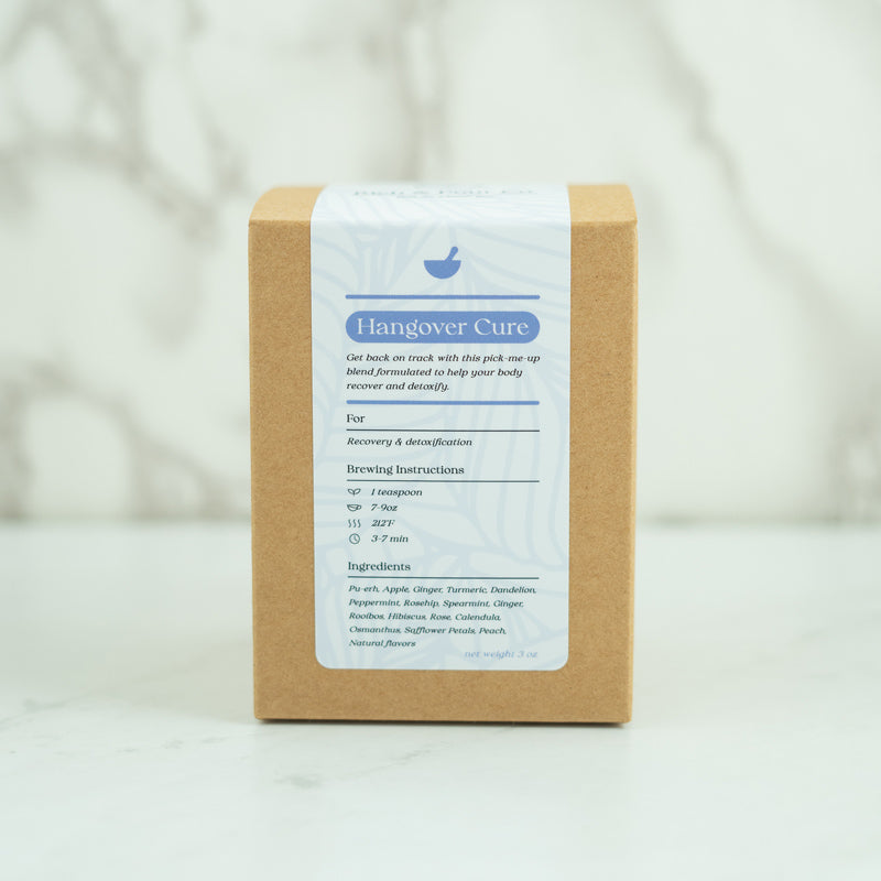 A vibrant package of Recovery: Ginger + Turmeric Pu-erh Blend tea, showcasing its eco-friendly design and colorful ingredients.