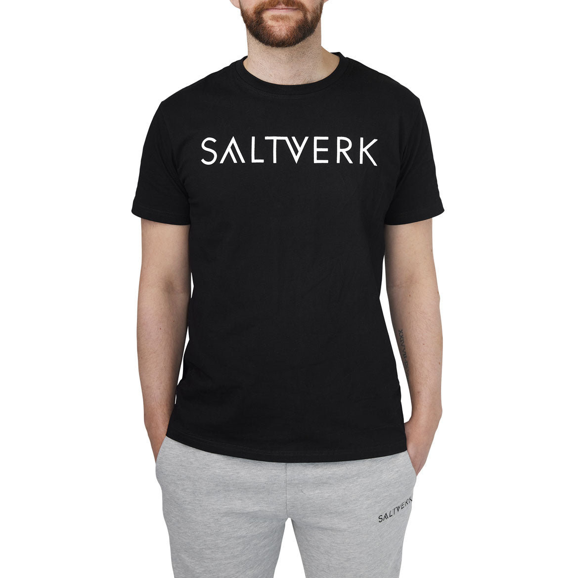 SALTVERK Black UNISEX T-Shirt displayed on a hanger, showcasing its soft cotton fabric and stylish design.