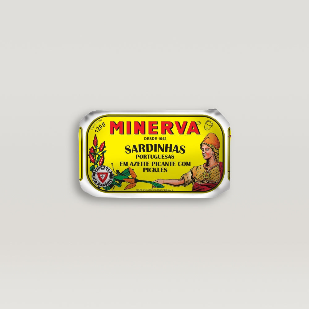 A can of sardines in spiced olive oil with pickles, showcasing the rich texture and vibrant colors of the dish.