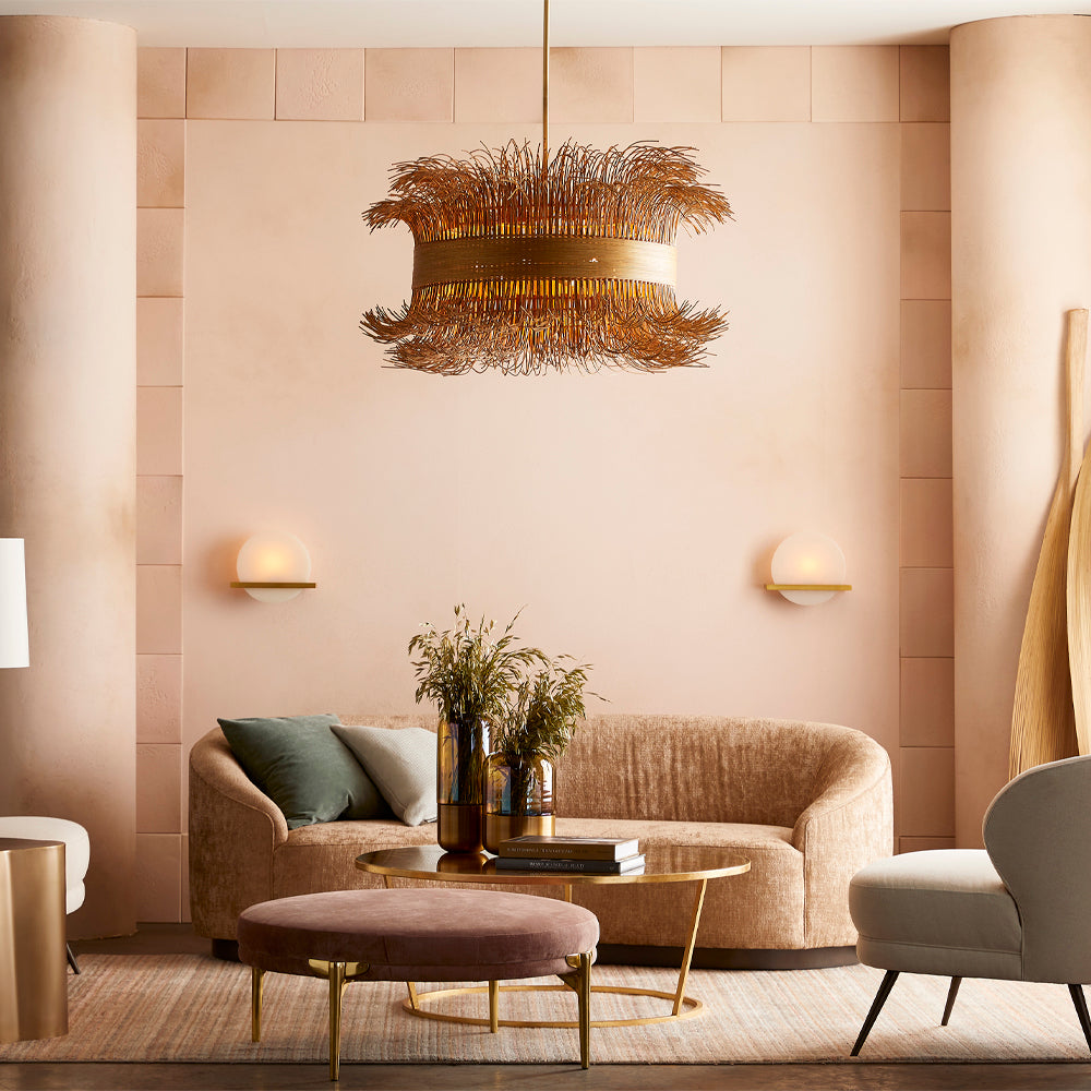 Savian Sconce featuring polished white onyx and antique brass frame, illuminating a stylish interior space.