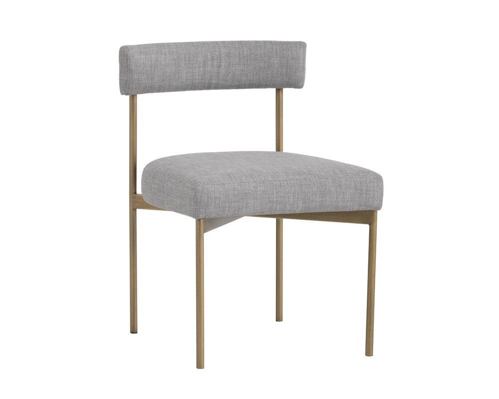 Seneca Dining Chair featuring an antique brass frame and arena cement fabric, showcasing a modern open back design.