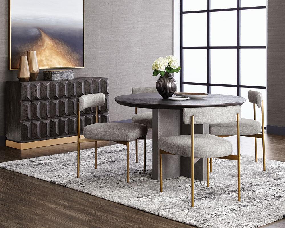 Seneca Dining Chair featuring an antique brass frame and arena cement fabric, showcasing a modern open back design.
