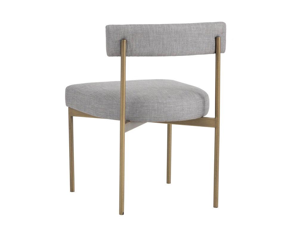 Seneca Dining Chair featuring an antique brass frame and arena cement fabric, showcasing a modern open back design.