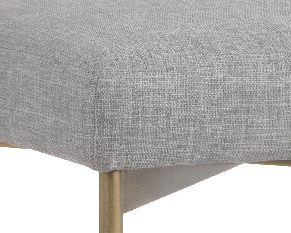 Seneca Dining Chair featuring an antique brass frame and arena cement fabric, showcasing a modern open back design.