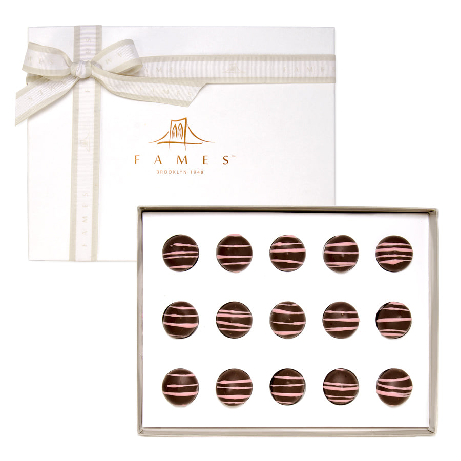 A beautifully arranged Super Berry Chocolate Gift Box featuring dark chocolate shells filled with vibrant berries.