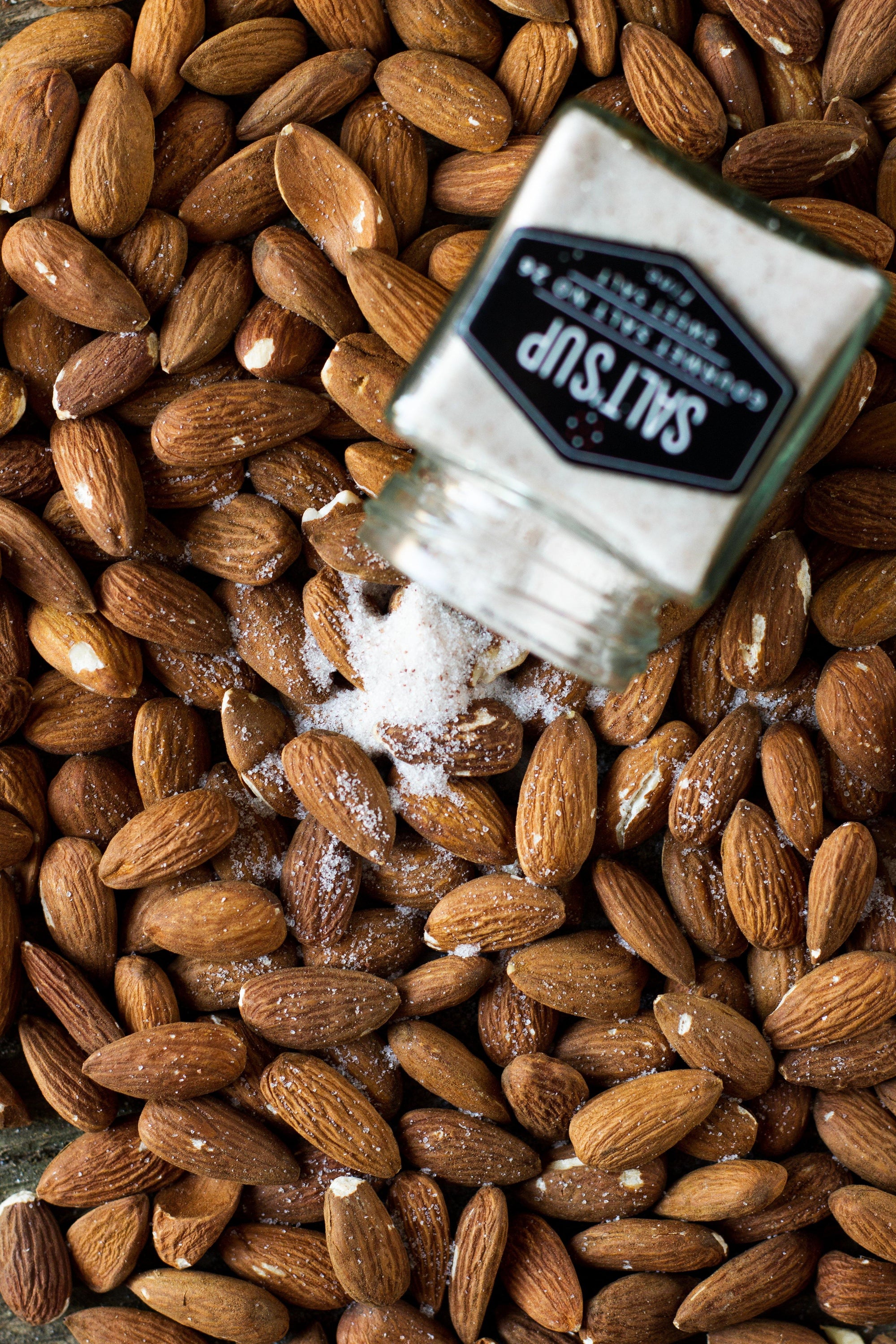 A jar of SWEET SALT fine, a mineral-rich seasoning salt from North America, showcasing its fine texture and packaging.