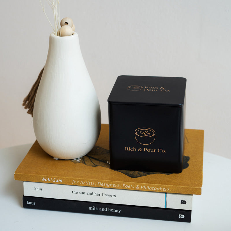 A set of stylish tea storage tins made from recycled steel, available in cubed, tall, and large sizes, showcasing their airtight design.