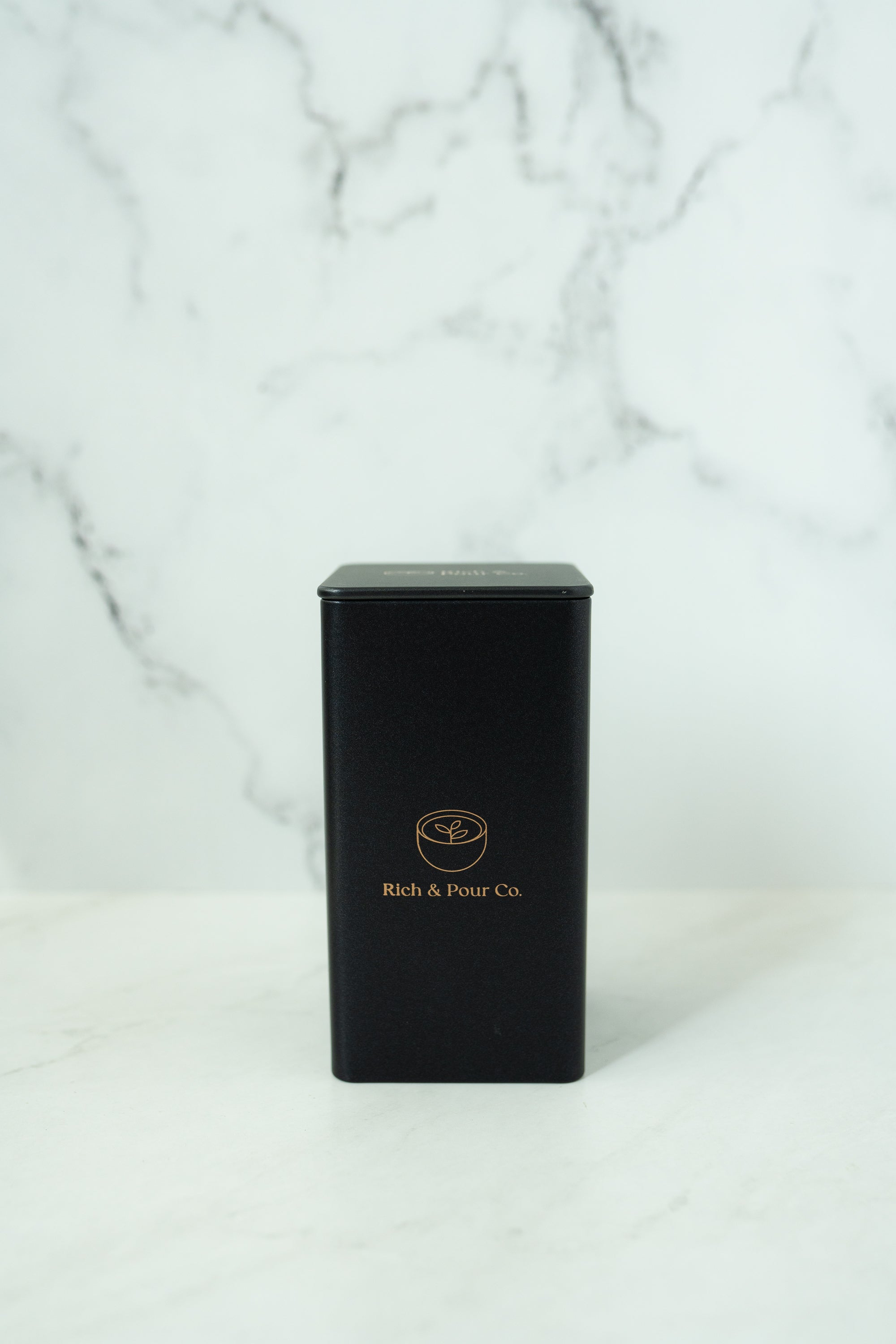 A set of stylish tea storage tins made from recycled steel, available in cubed, tall, and large sizes, showcasing their airtight design.