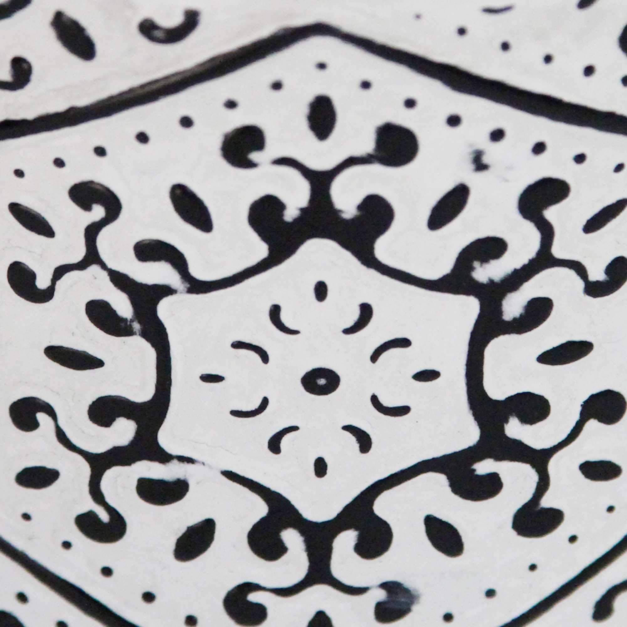 A 10-inch tall black and white metal vase with a distressed finish, featuring a textured pattern reminiscent of vintage milk jugs.