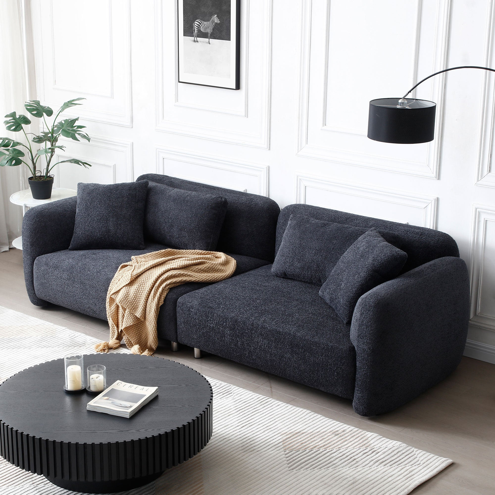 110.23 Inches Teddy Velvet Sofa in black with four plush pillows, showcasing a mid-century modern design suitable for living rooms.