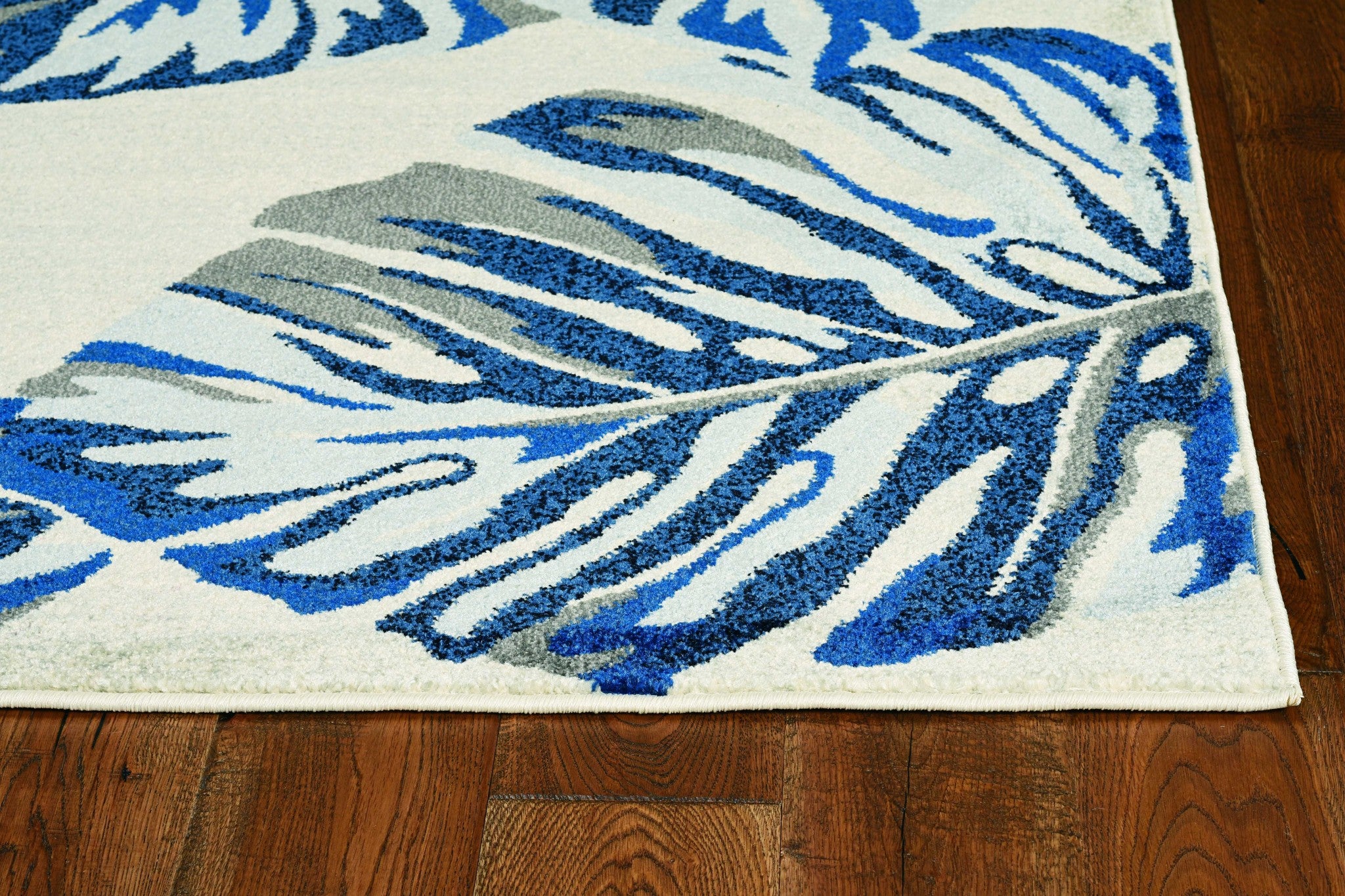 10x13 inches grey blue machine woven tropical leaves indoor area rug showcasing intricate leaf patterns and a modern design.
