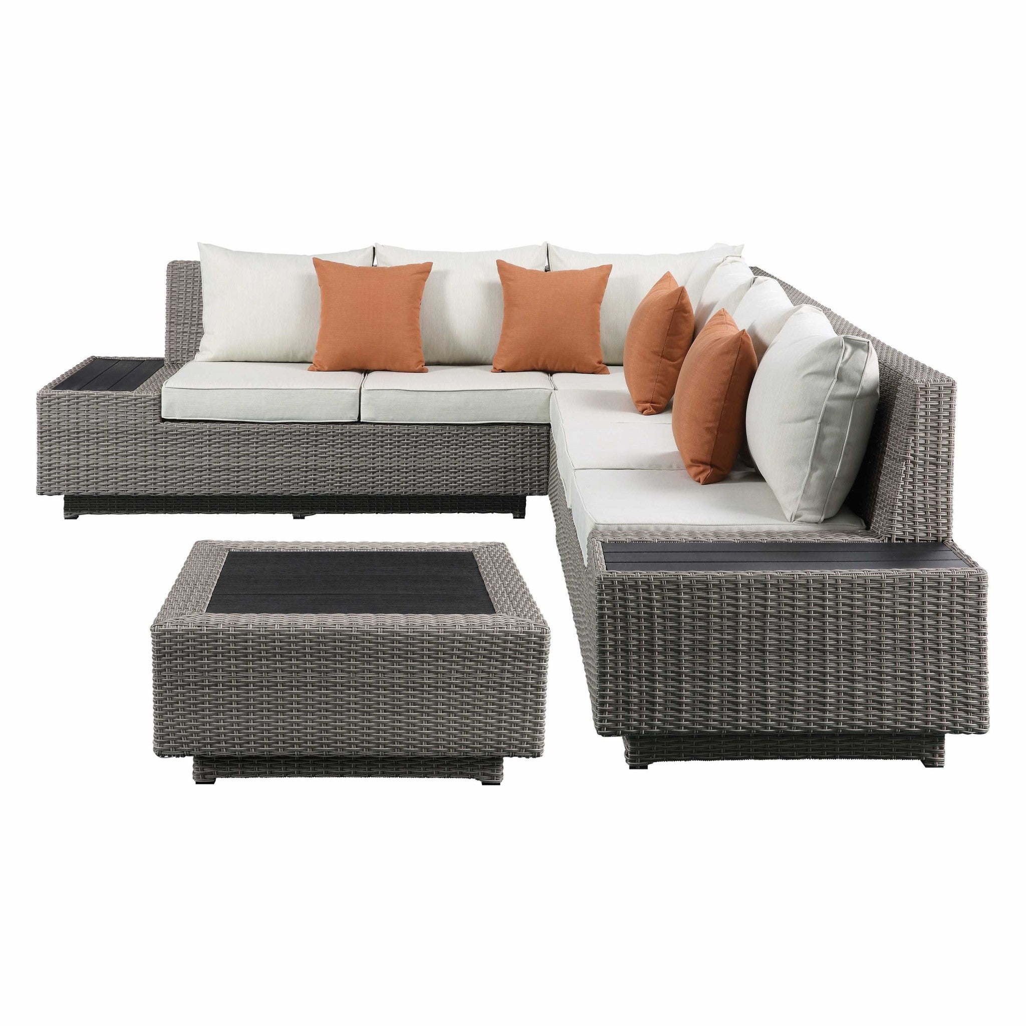 A spacious 126x100-inch beige fabric and gray wicker patio sectional set with plush cushions and vibrant orange pillows, perfect for outdoor relaxation.