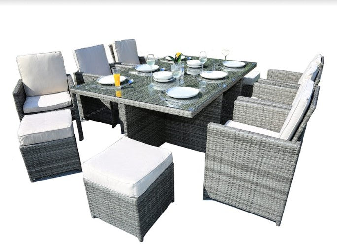 Gray 11-piece outdoor dining set featuring six chairs, four footstools, and a large dining table with glass top, perfect for outdoor gatherings.