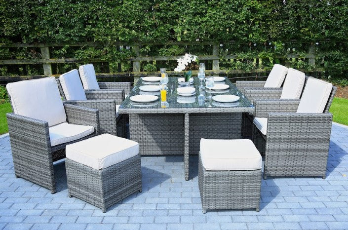 Gray 11-piece outdoor dining set featuring six chairs, four footstools, and a large dining table with glass top, perfect for outdoor gatherings.