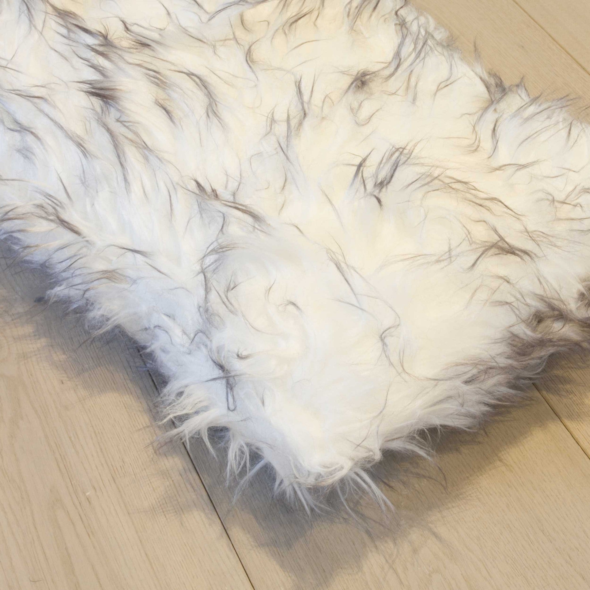 Two luxurious gradient gray faux fur pillows, showcasing a plush texture and elegant design, perfect for home decor.