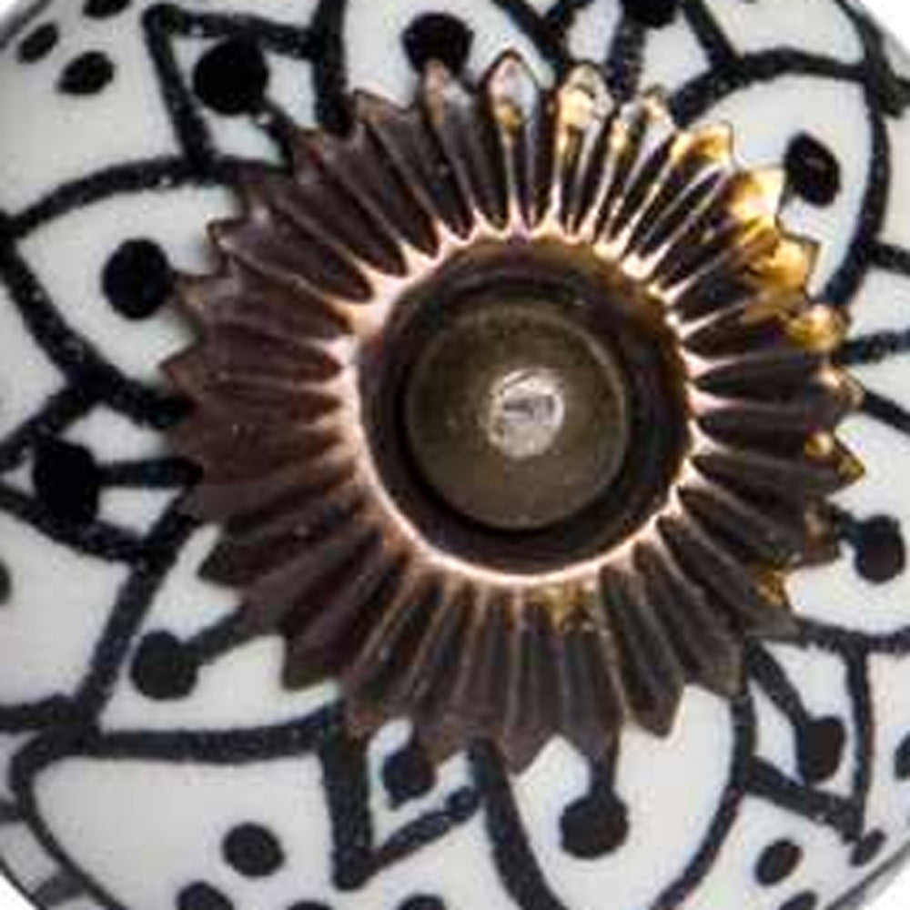 A pack of 12 black, white, and copper ceramic knobs, each measuring 1.5 inches, showcasing a hand-painted floral design.