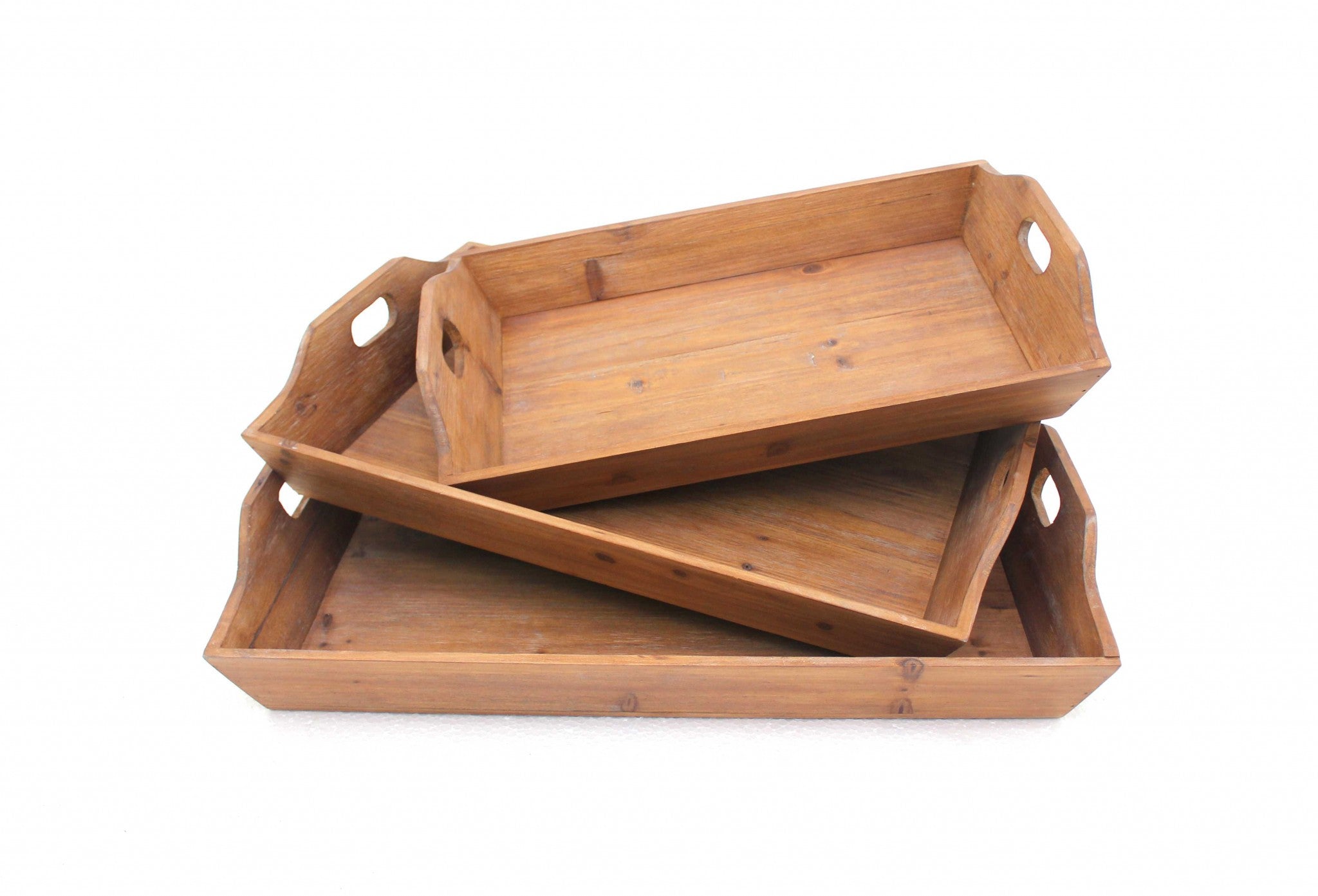 Three-piece brown wooden serving tray set with cut-out handles, showcasing natural wood texture and varying sizes for versatile serving.