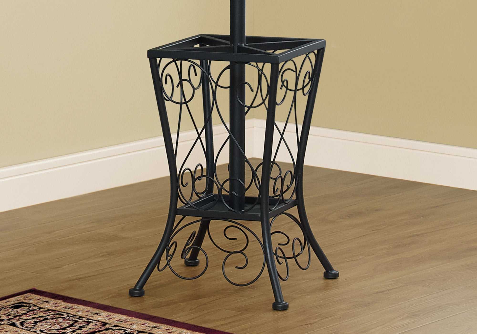 Black metal umbrella holder coat rack with 8 hooks and scrolled basket design, perfect for entryways.