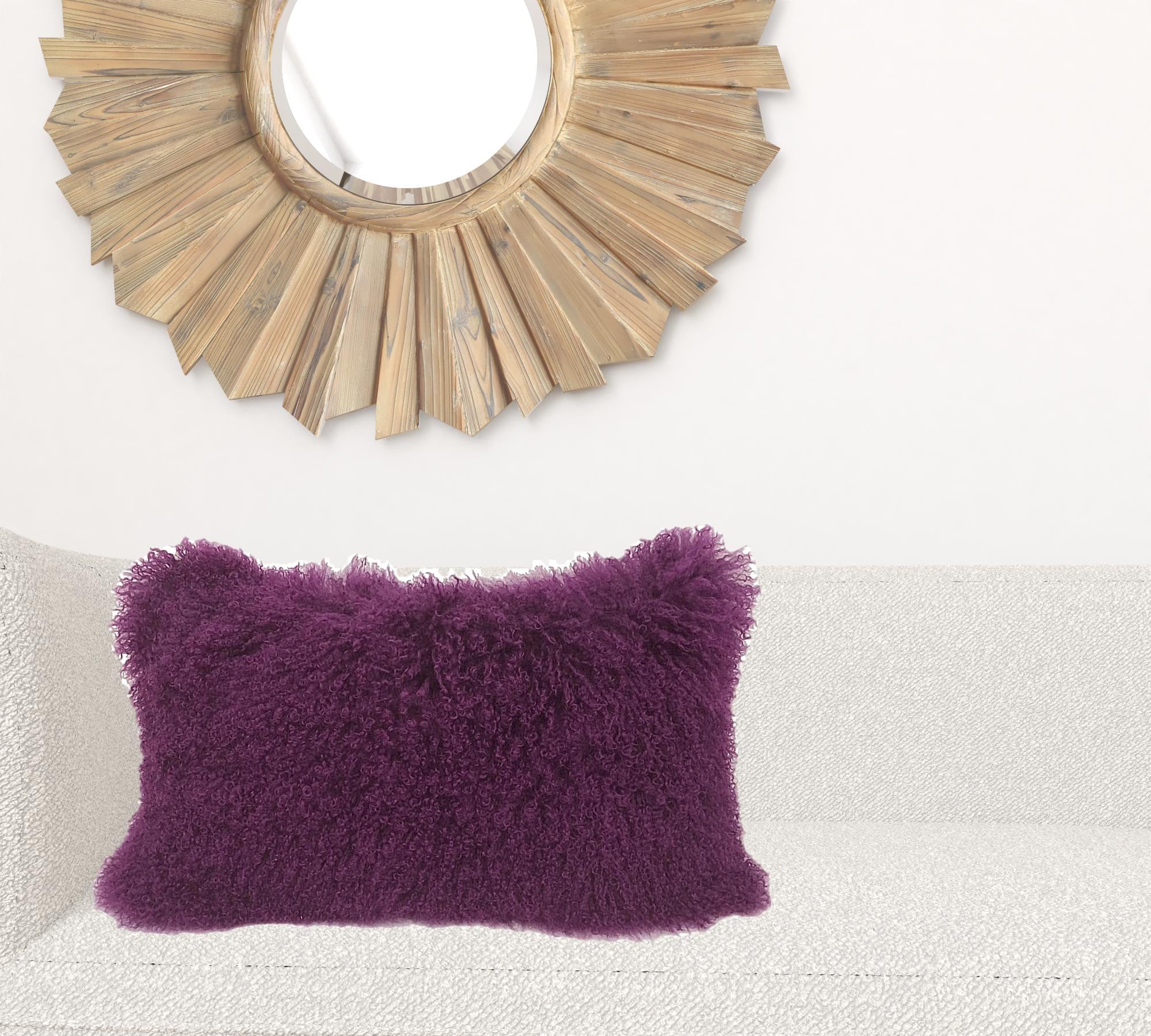 A luxurious 17-inch purple genuine Tibetan lamb fur pillow with a soft microsuede backing, elegantly displayed on a sofa.