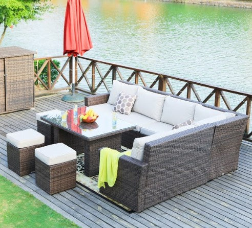 Brown 8-piece outdoor sectional sofa set featuring two side sofas, one corner sofa, one middle sofa, a table with tempered glass, and three ottomans.