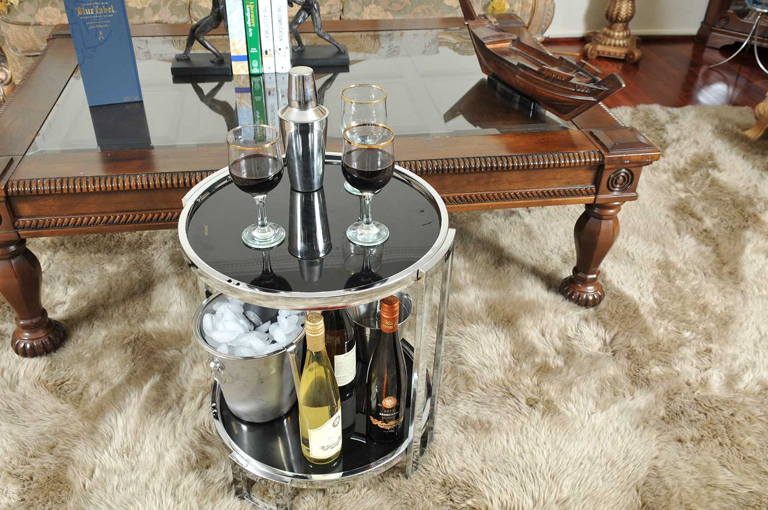 A stylish chrome round end table featuring a sleek chrome frame and black tempered glass top, perfect for modern home decor.