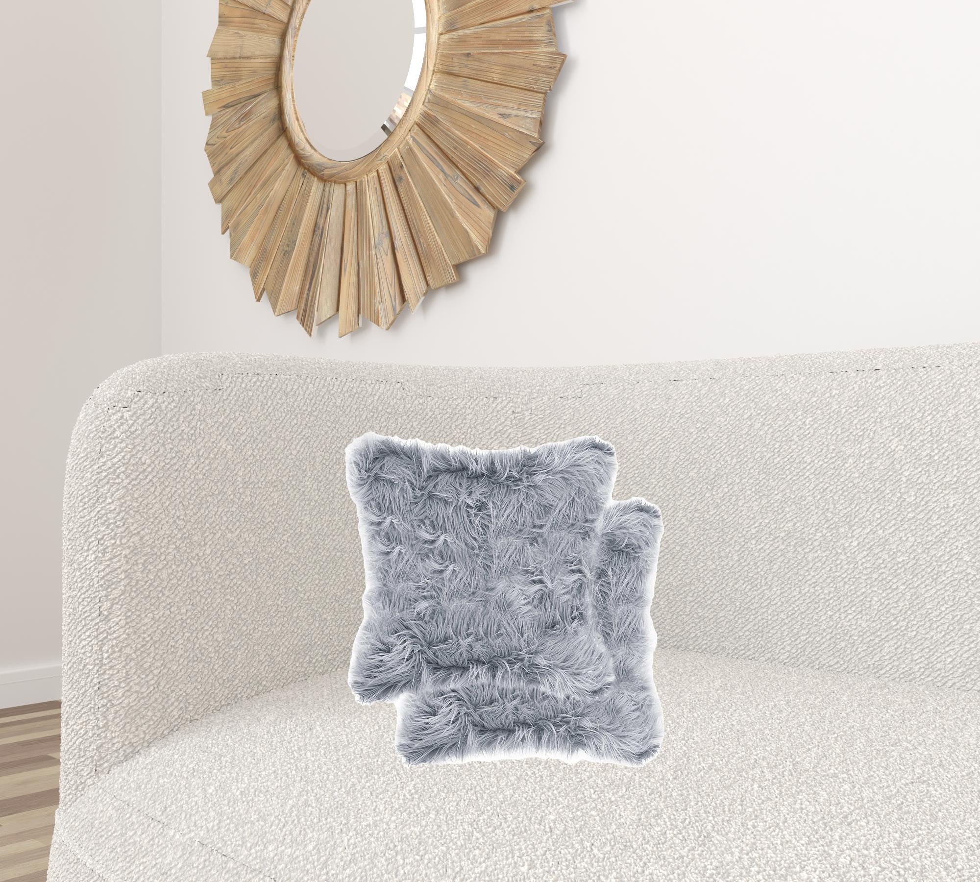 Two luxurious grey faux fur pillows, 18x18 inches, showcasing a soft and plush texture, perfect for home decor.