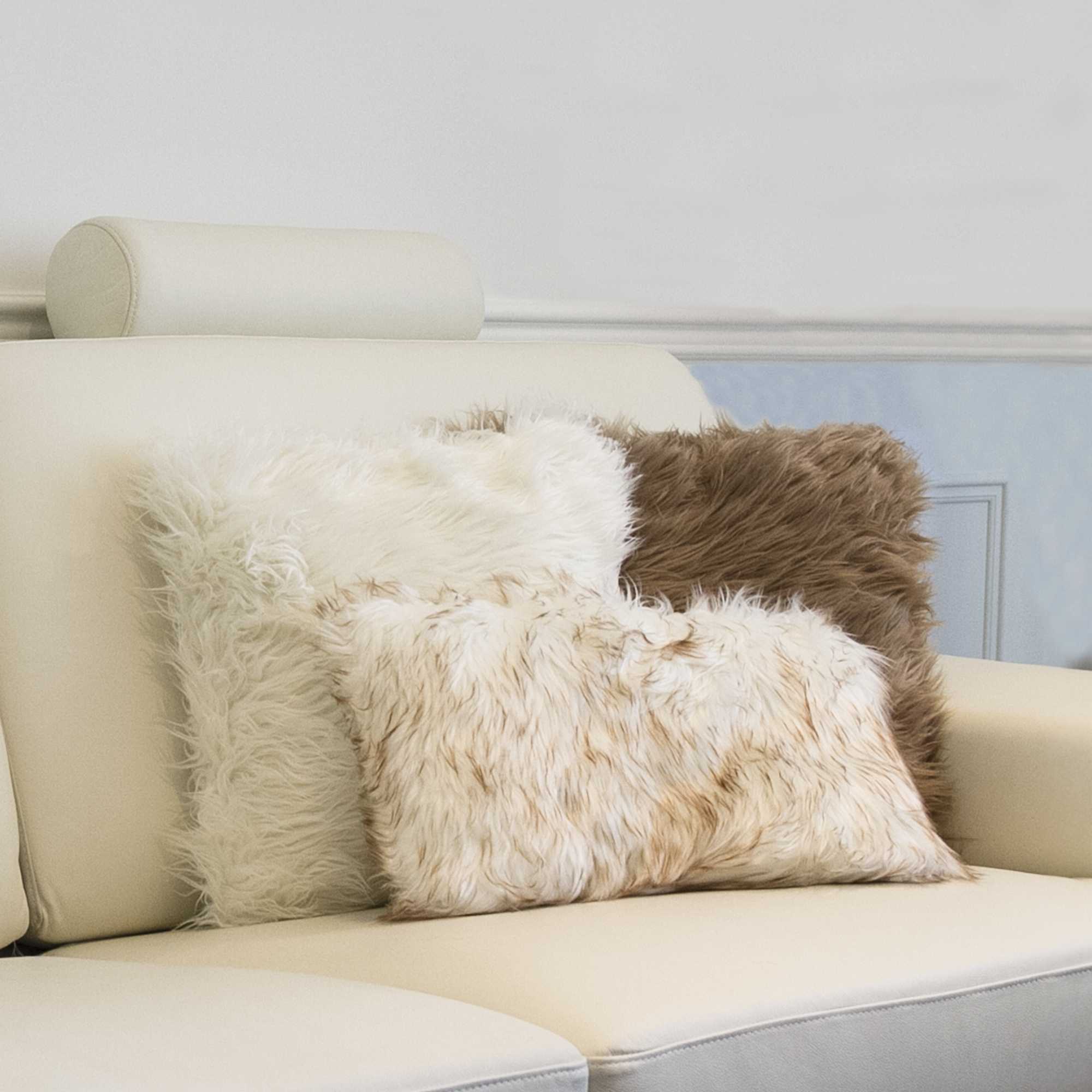 Two luxurious off white faux fur pillows, 18x18 inches, showcasing a plush texture and elegant design, perfect for home decor.