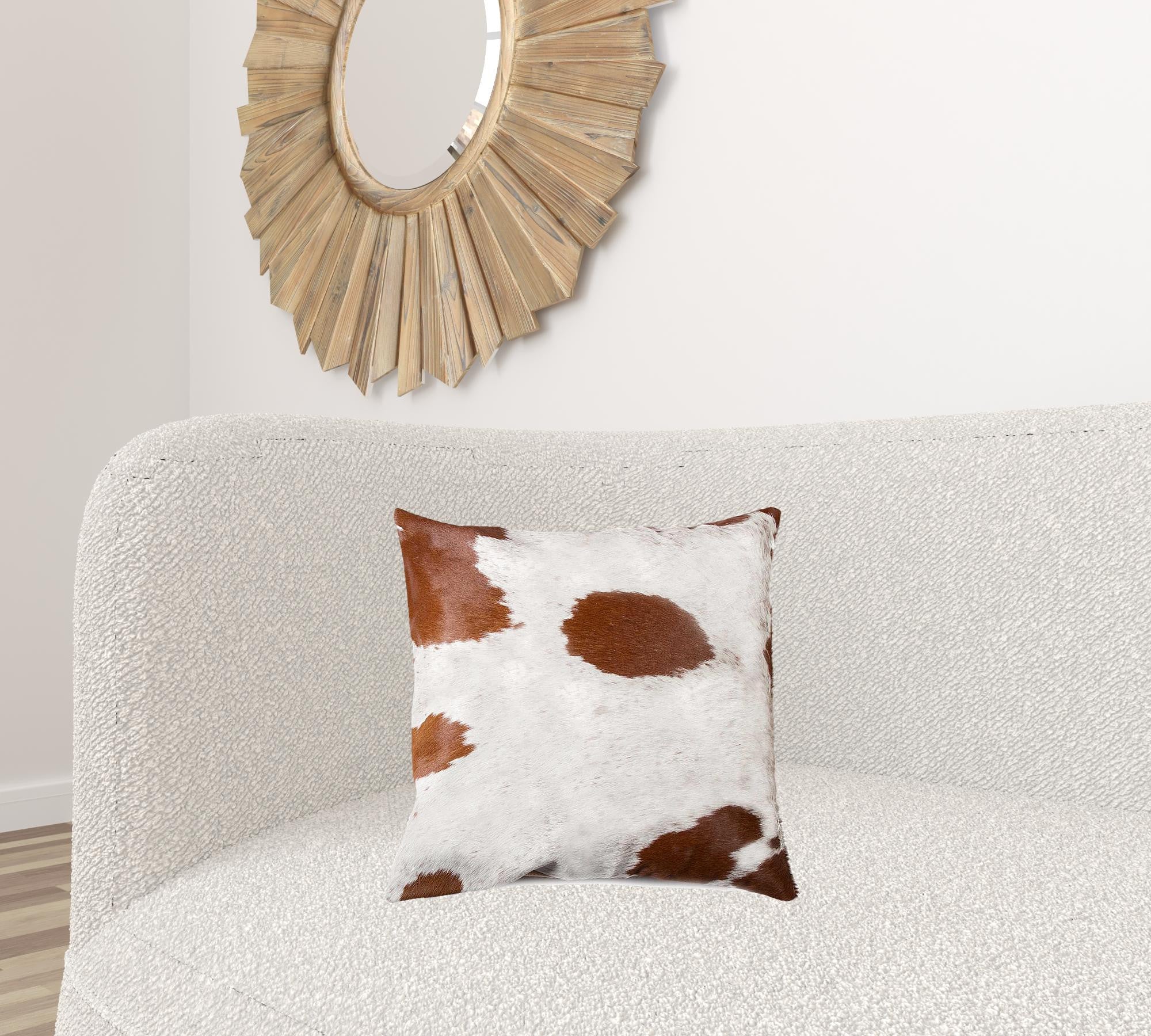 Luxurious 18x18 inches white and brown cowhide pillow with unique mottling and soft microsuede backing, featuring a hidden zipper closure.