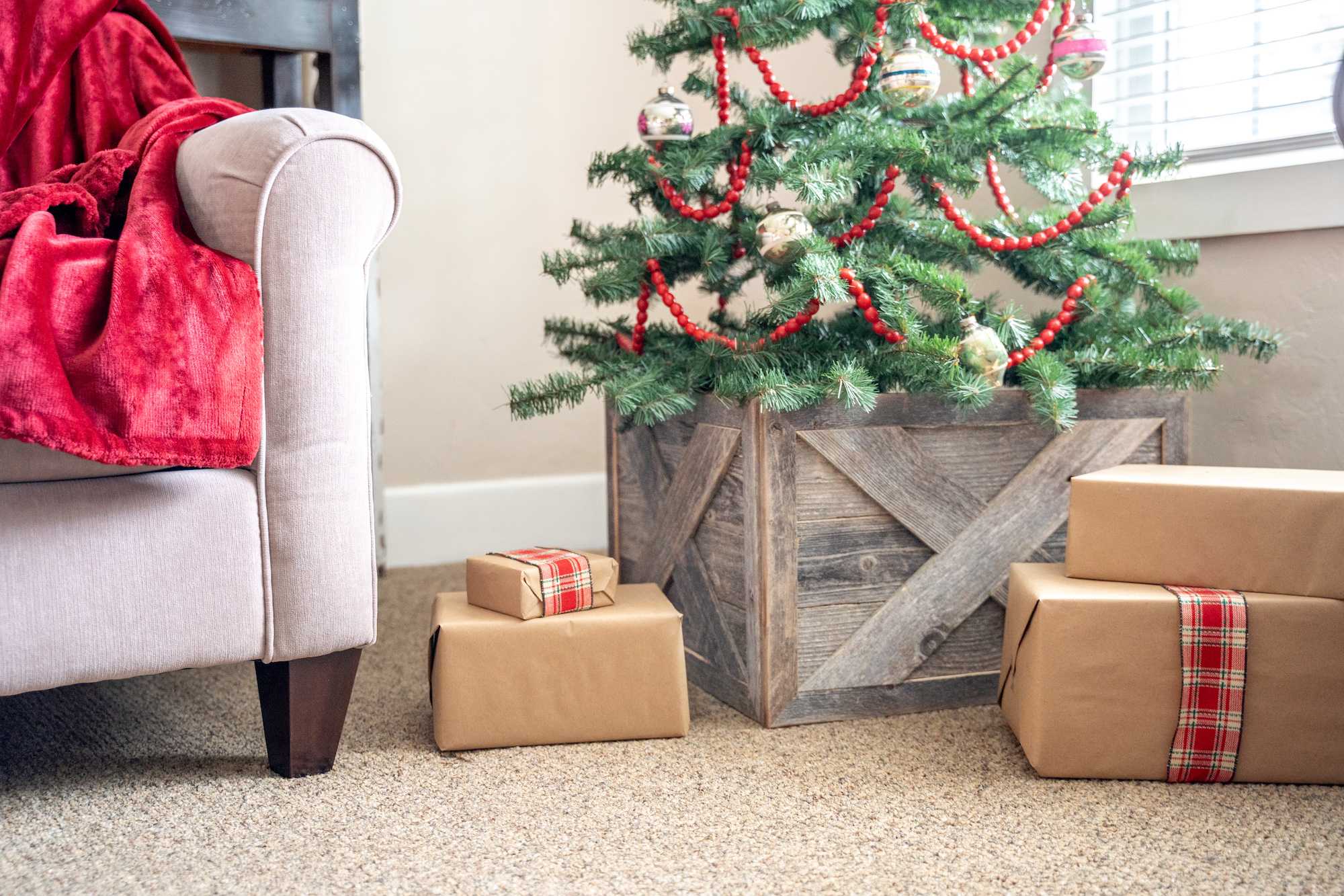 19-inch Natural Weathered Gray Christmas Tree Collar made from reclaimed wood with rustic X design, perfect for enhancing holiday decor.