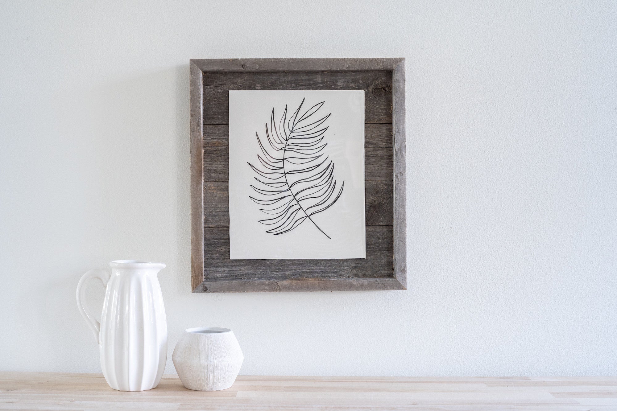 Rustic weathered gray picture frame holding an 11x14 photo, made from reclaimed wood with plexiglass protection.