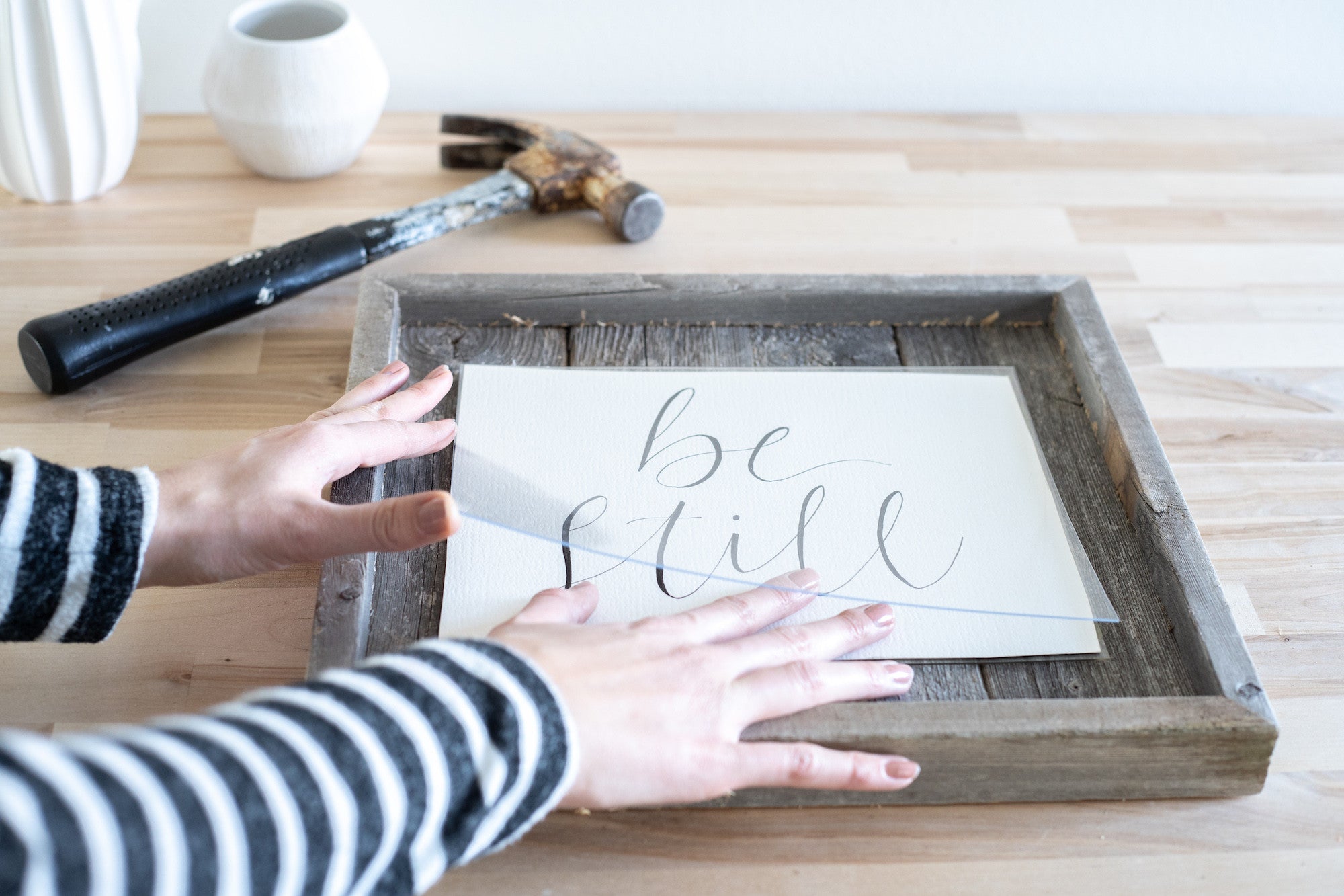 Rustic weathered gray picture frame holding an 11x14 photo, made from reclaimed wood with plexiglass protection.