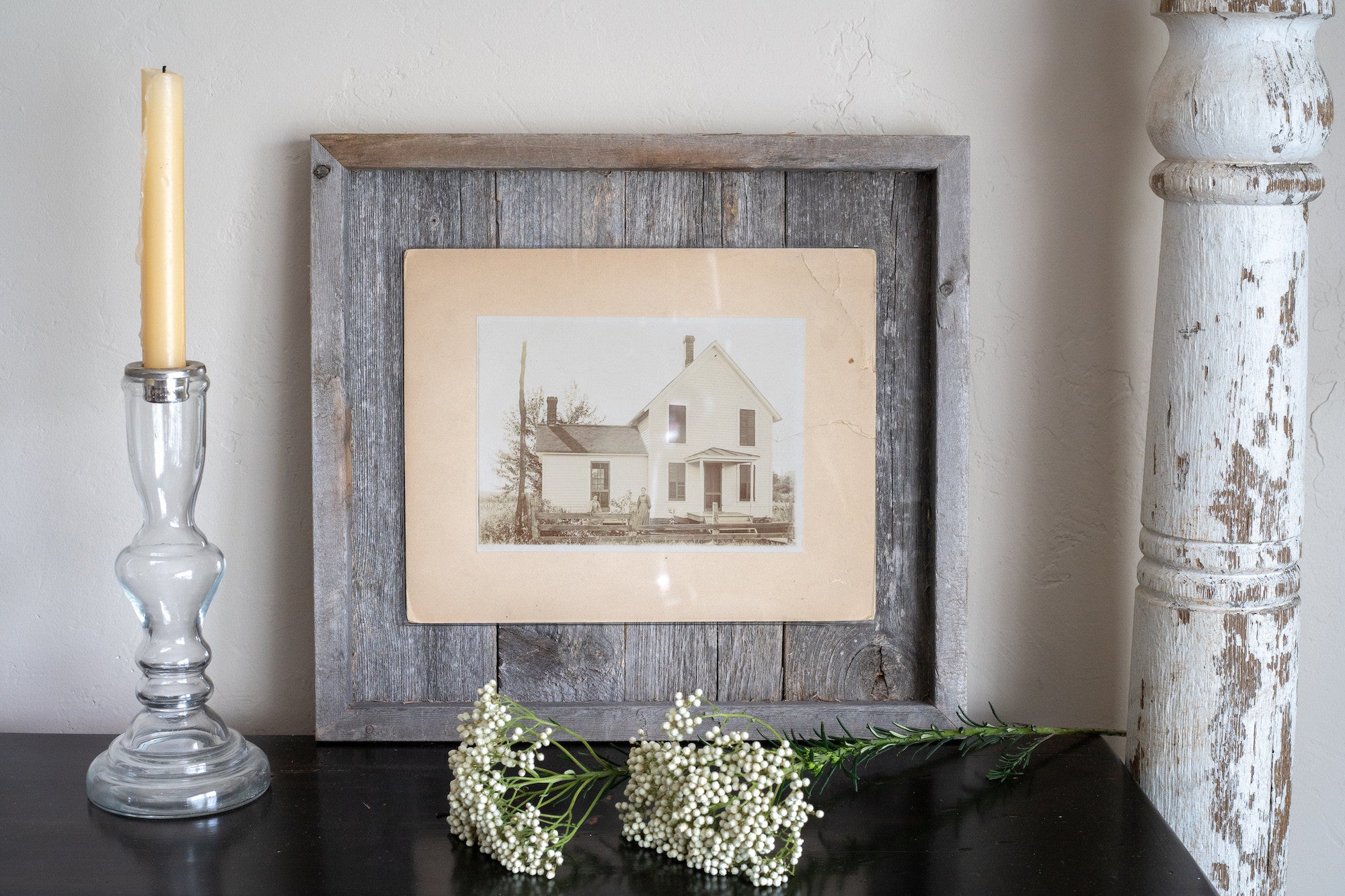 Rustic weathered gray picture frame holding an 11x14 photo, made from reclaimed wood with plexiglass protection.