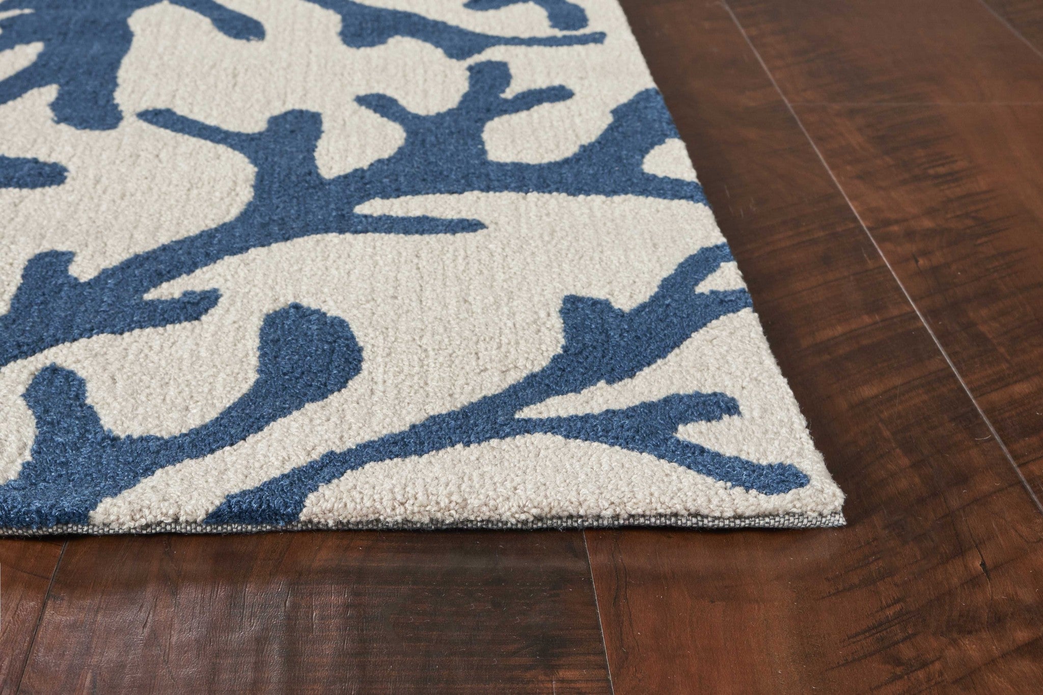 A stylish 2' x 4' area rug in ivory and blue, featuring a hand-hooked design, perfect for contemporary home decor.