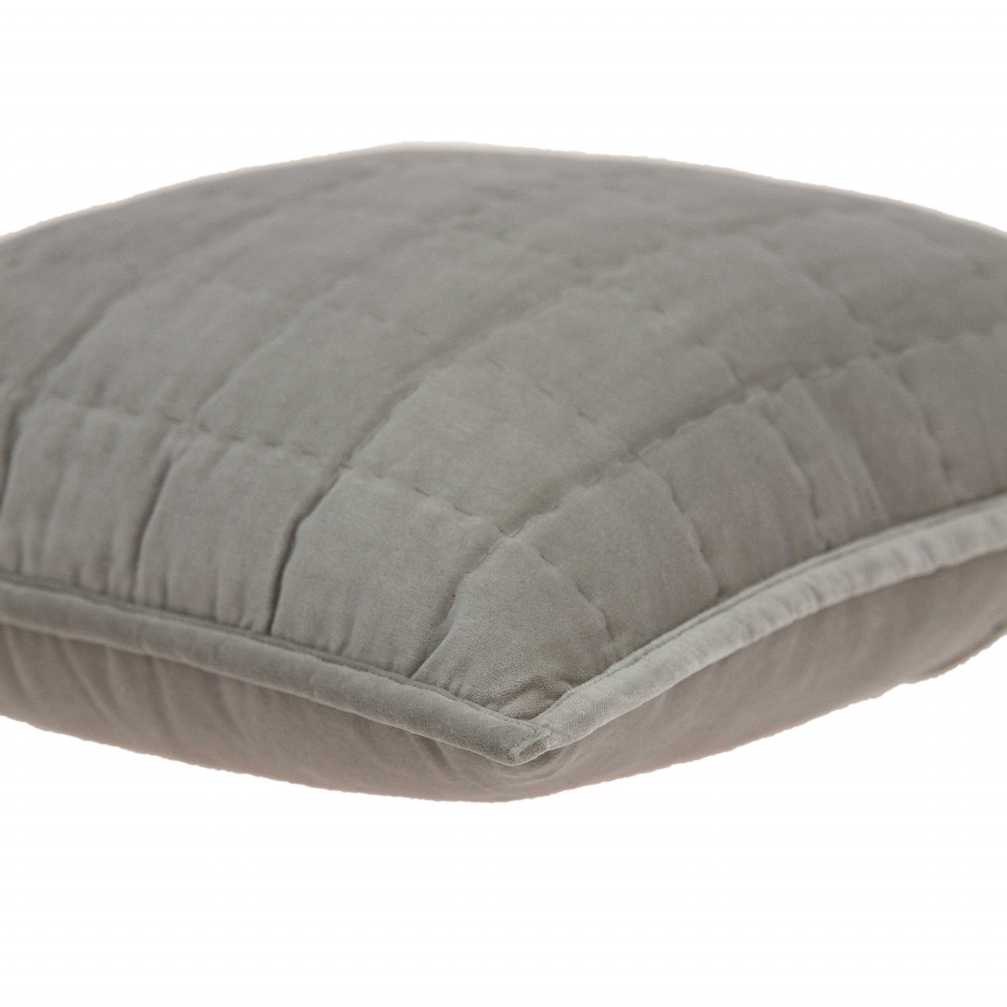 Transitional gray solid quilted pillow measuring 20x7x20 inches, featuring a soft cotton and viscose blend for comfort and style.