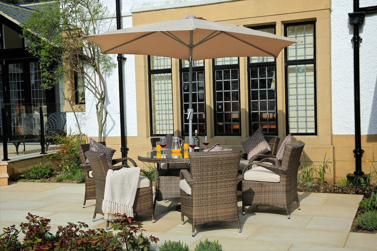 Brown 7-piece outdoor dining set featuring six chairs and a round table with tempered glass top, perfect for outdoor dining.