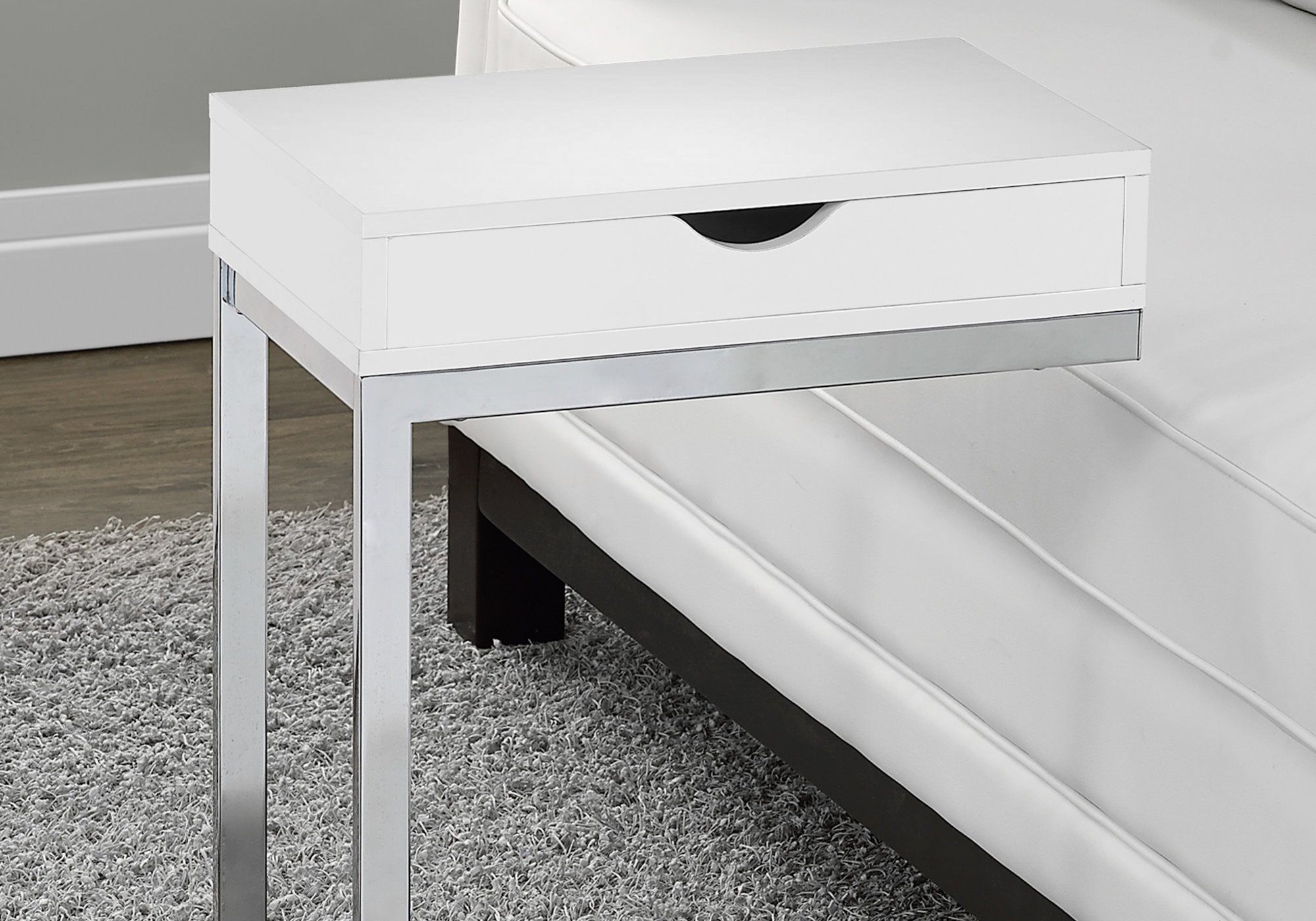 A stylish 24.5-inch white accent table with chromed metal accents, featuring a storage drawer on either side.