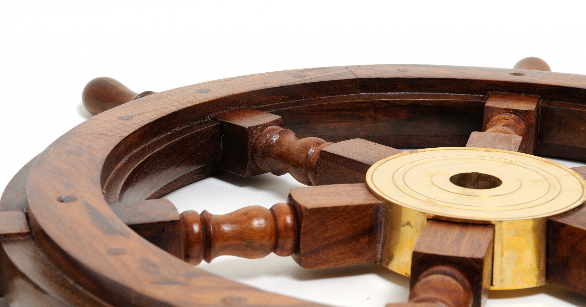 A beautifully crafted 24-inch ship wheel made of rosewood with a golden brass hub, showcasing a classic nautical design.