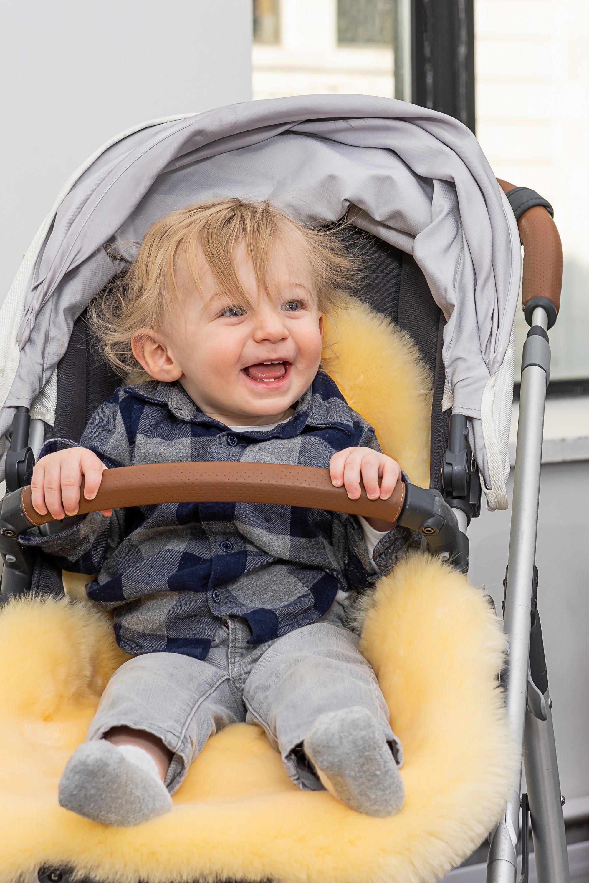 Cream cozy baby medium lambskin play rug measuring 24x36 inches, showcasing its soft texture and luxurious design.