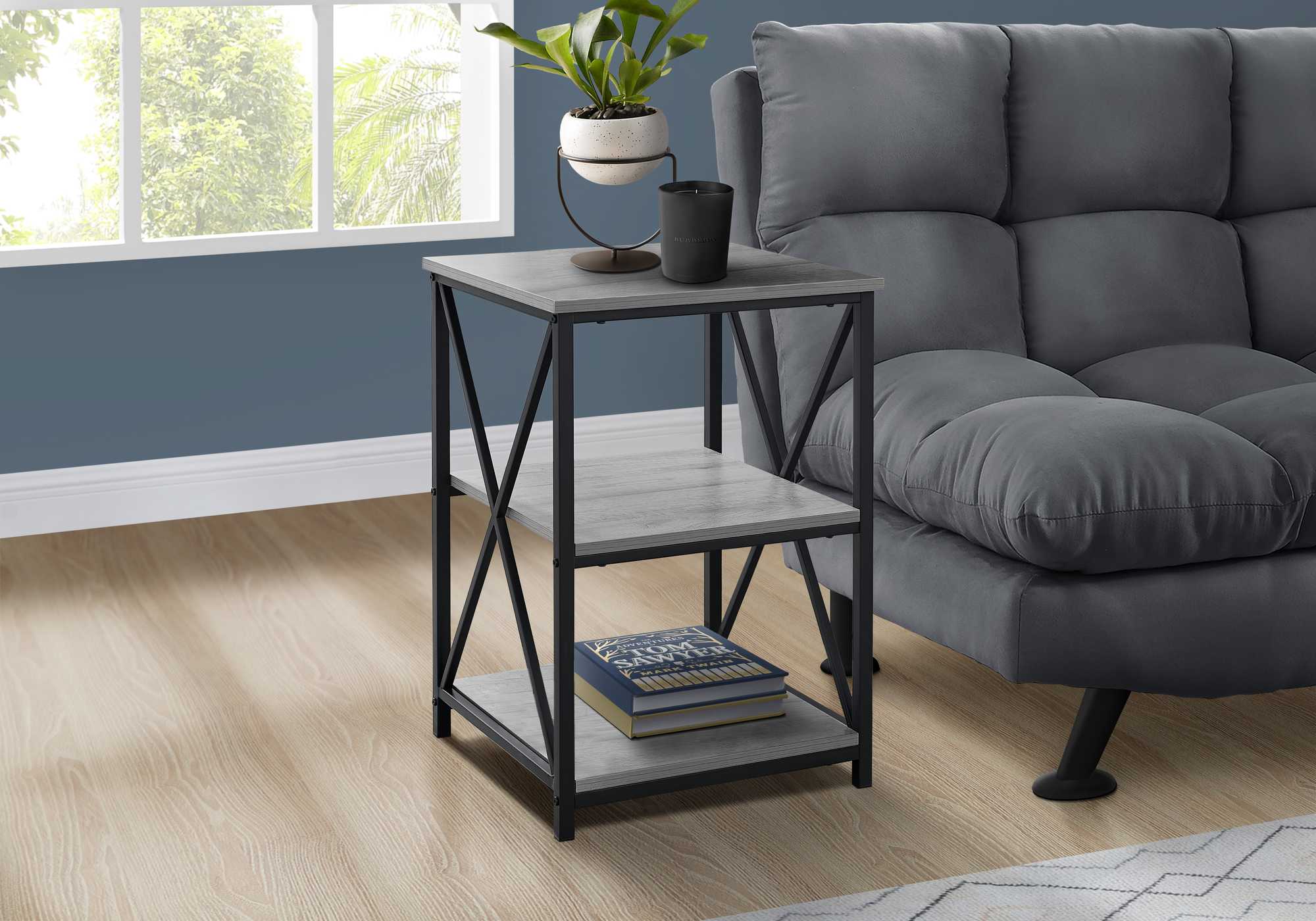 26-inch rectangular grey black metal accent table with X design legs and two open shelves.