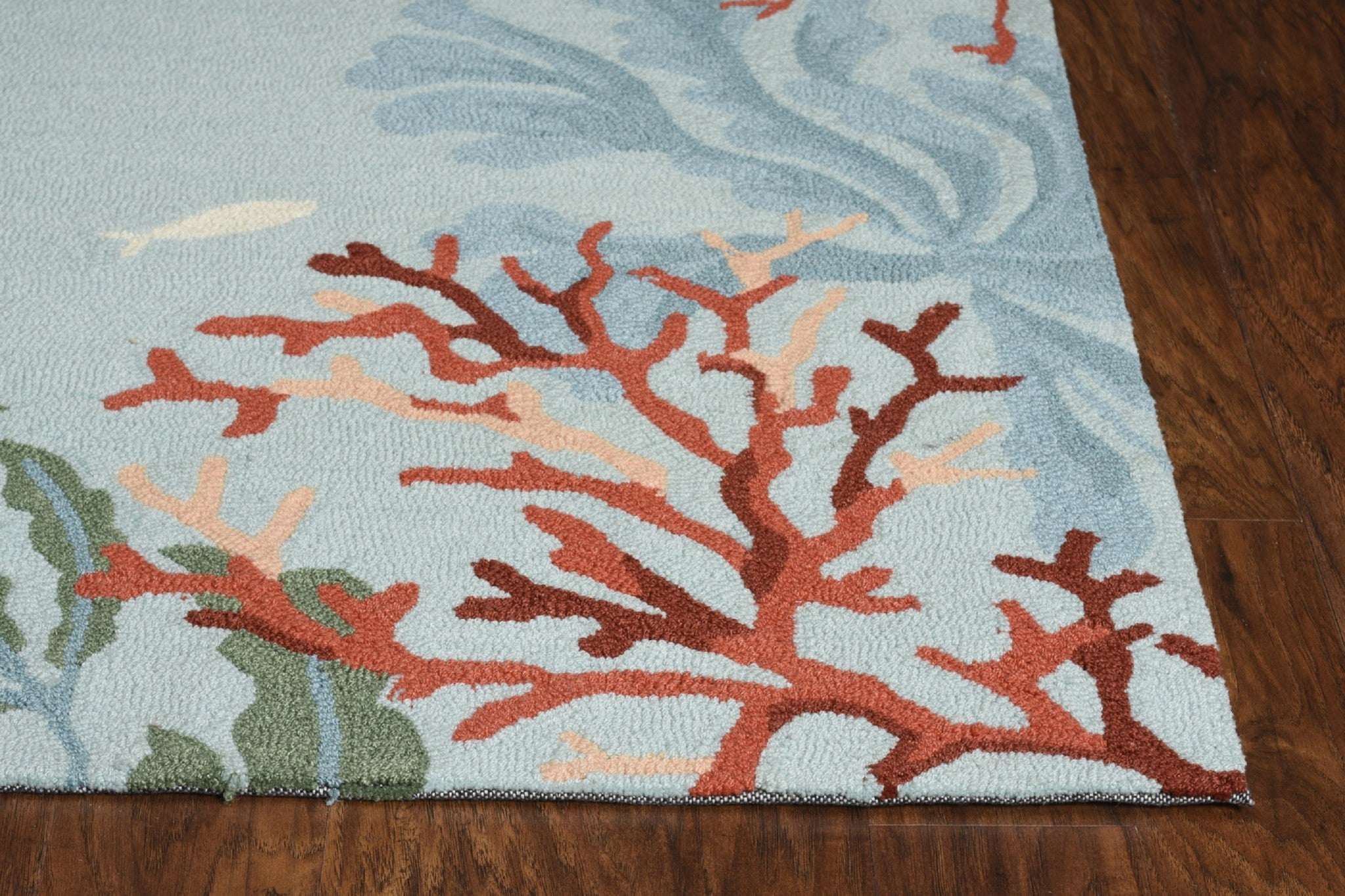 A vibrant blue polyester accent rug measuring 2 inches by 3 inches, showcasing hand-hooked craftsmanship and a contemporary design.