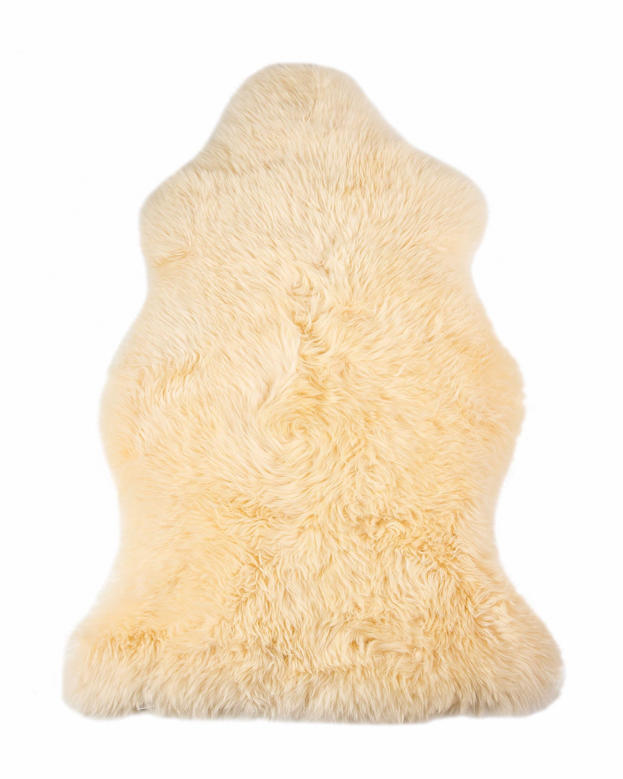 A luxurious 2x3 inches cream New Zealand natural sheepskin rug with a soft texture, perfect for enhancing home decor.