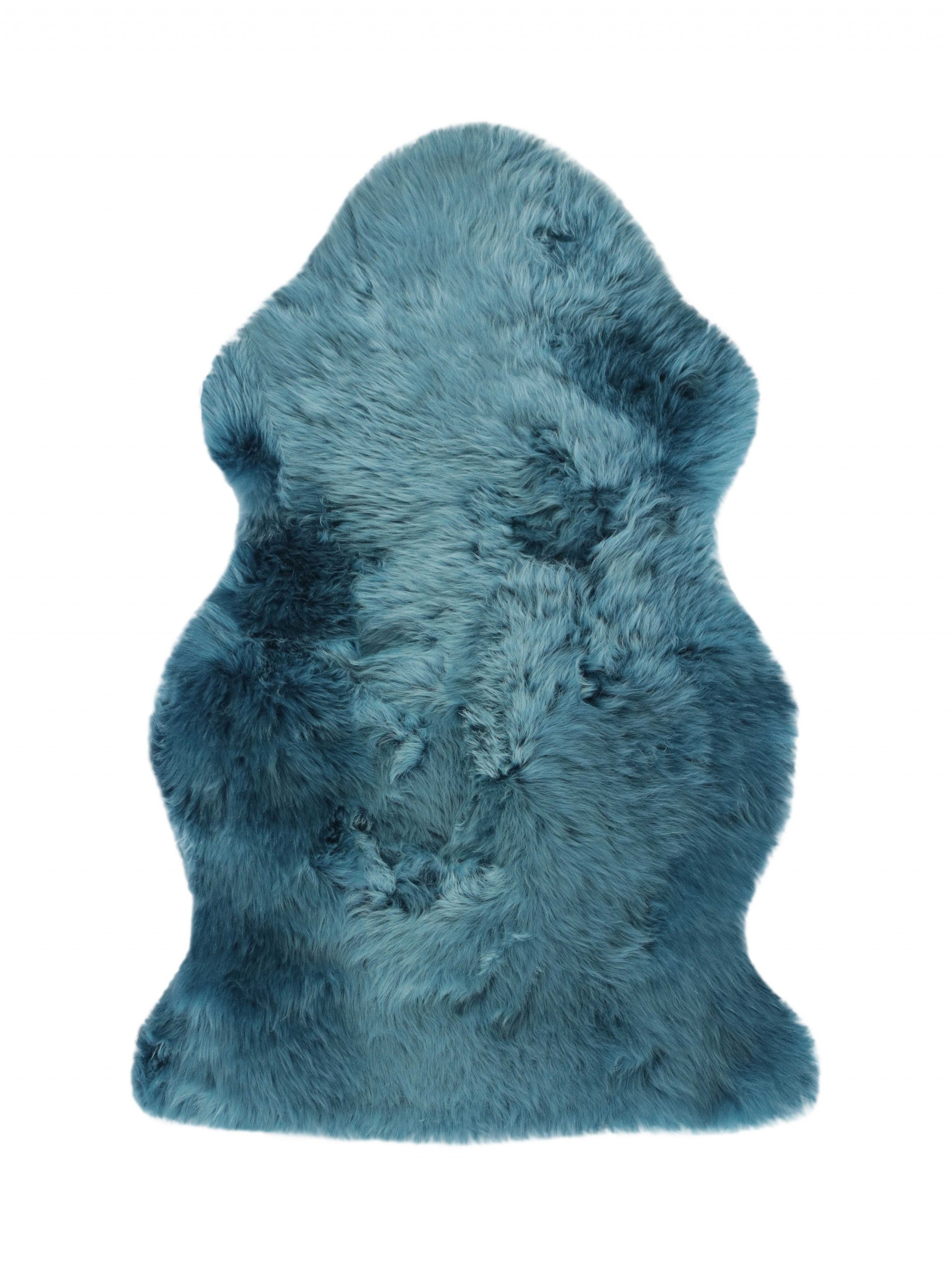 A luxurious 2x3 teal New Zealand natural sheepskin rug showcasing its plush texture and vibrant color, perfect for home decor.