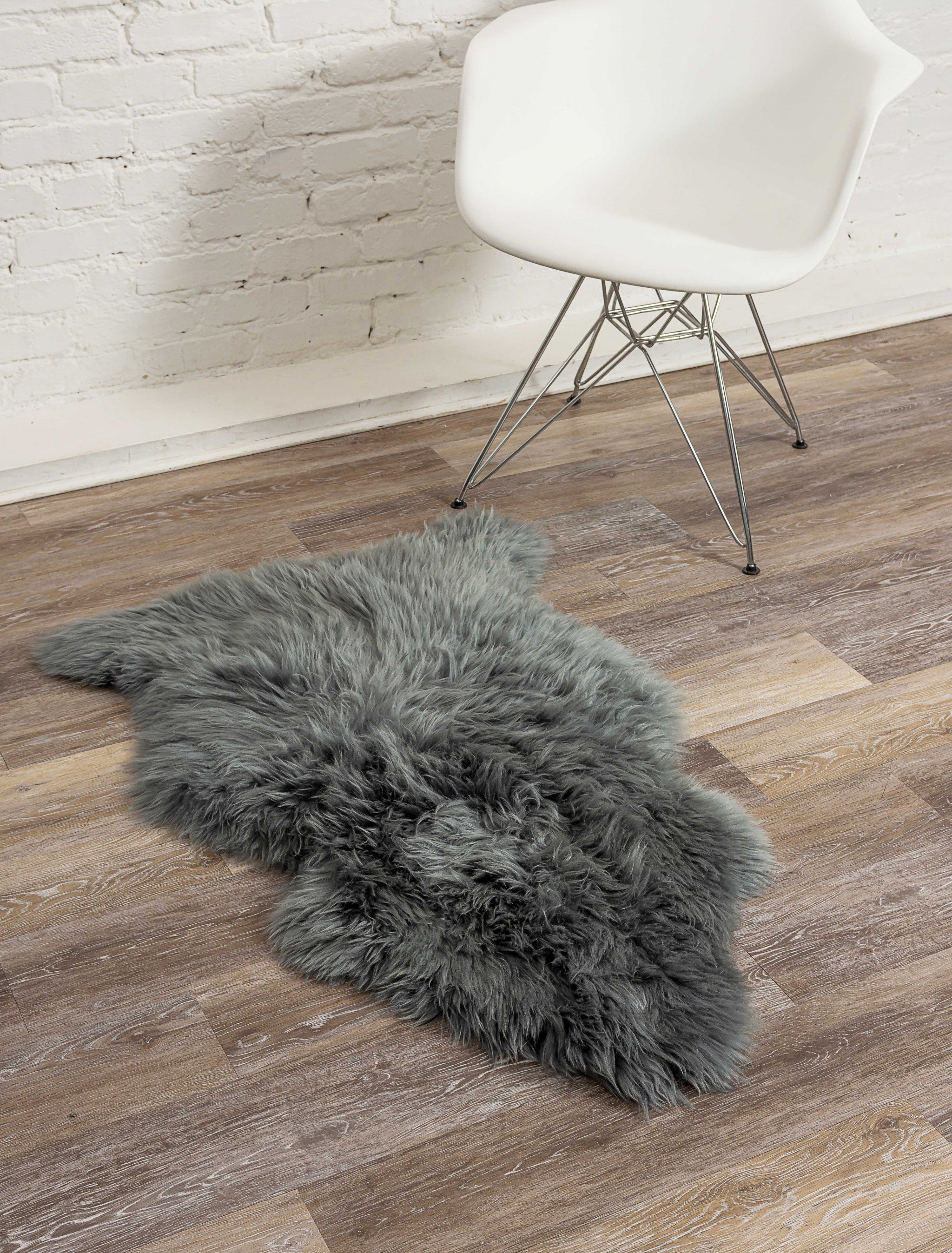 A luxurious 2x3 inches warm gray New Zealand natural sheepskin rug showcasing its soft texture and elegant color, perfect for home decor.