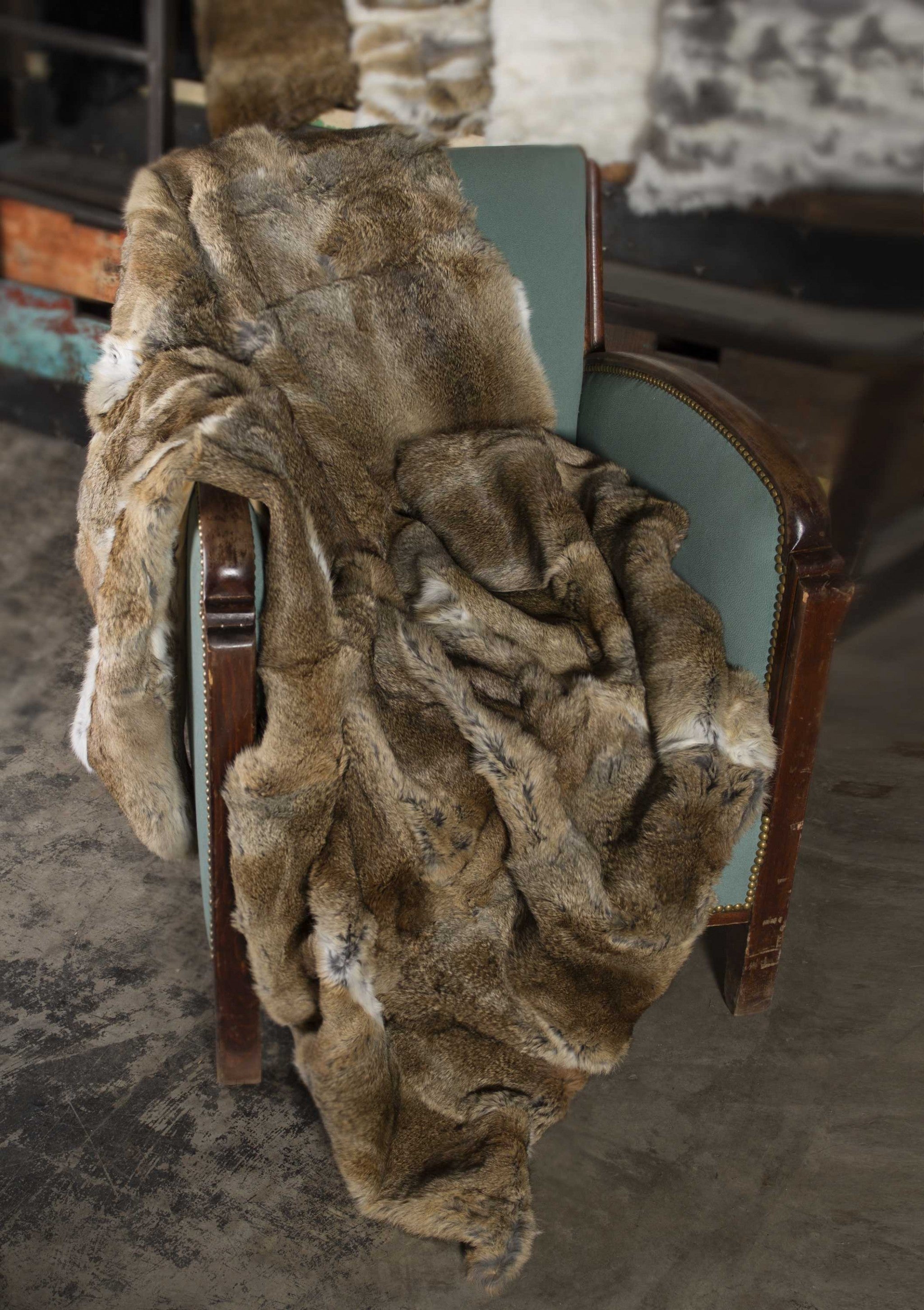 A luxurious 100% natural rabbit fur throw blanket in hazelnut color, showcasing its plush texture and elegant design.