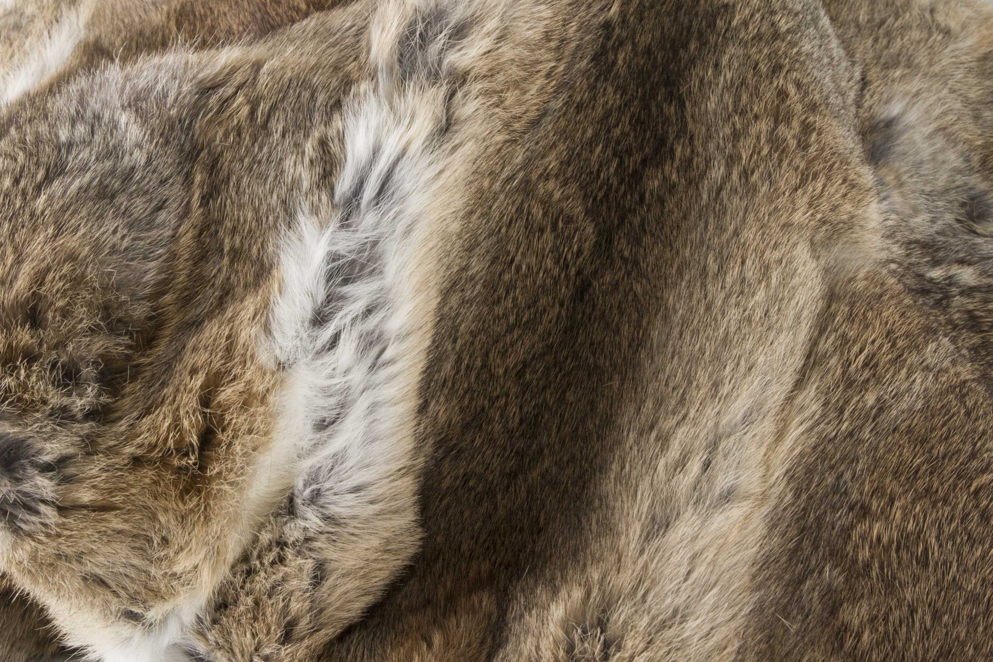 A luxurious 100% natural rabbit fur throw blanket in hazelnut color, showcasing its plush texture and elegant design.