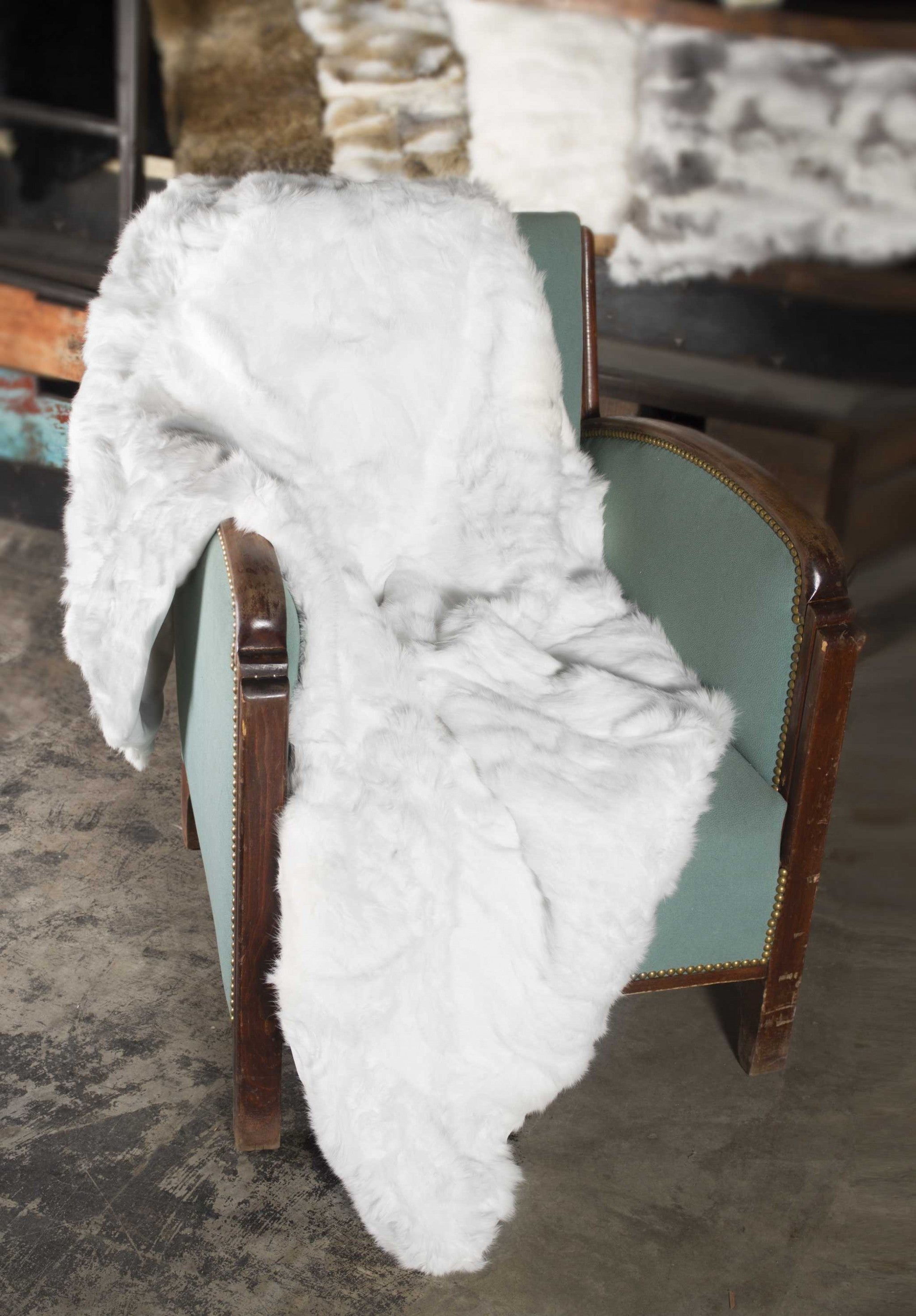 A luxurious 100% natural rabbit fur white throw blanket, showcasing its soft texture and elegant design, perfect for home decor.